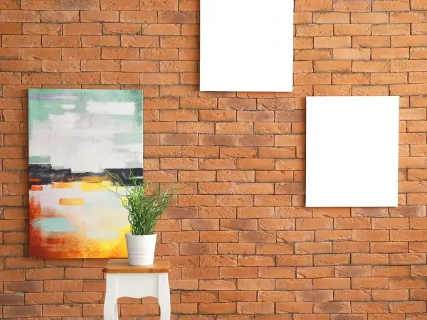 Applying adhesive hook to cement wall for hanging artwork